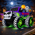 Inflatable black monster truck with a skull grille and skeleton driver glowing at night