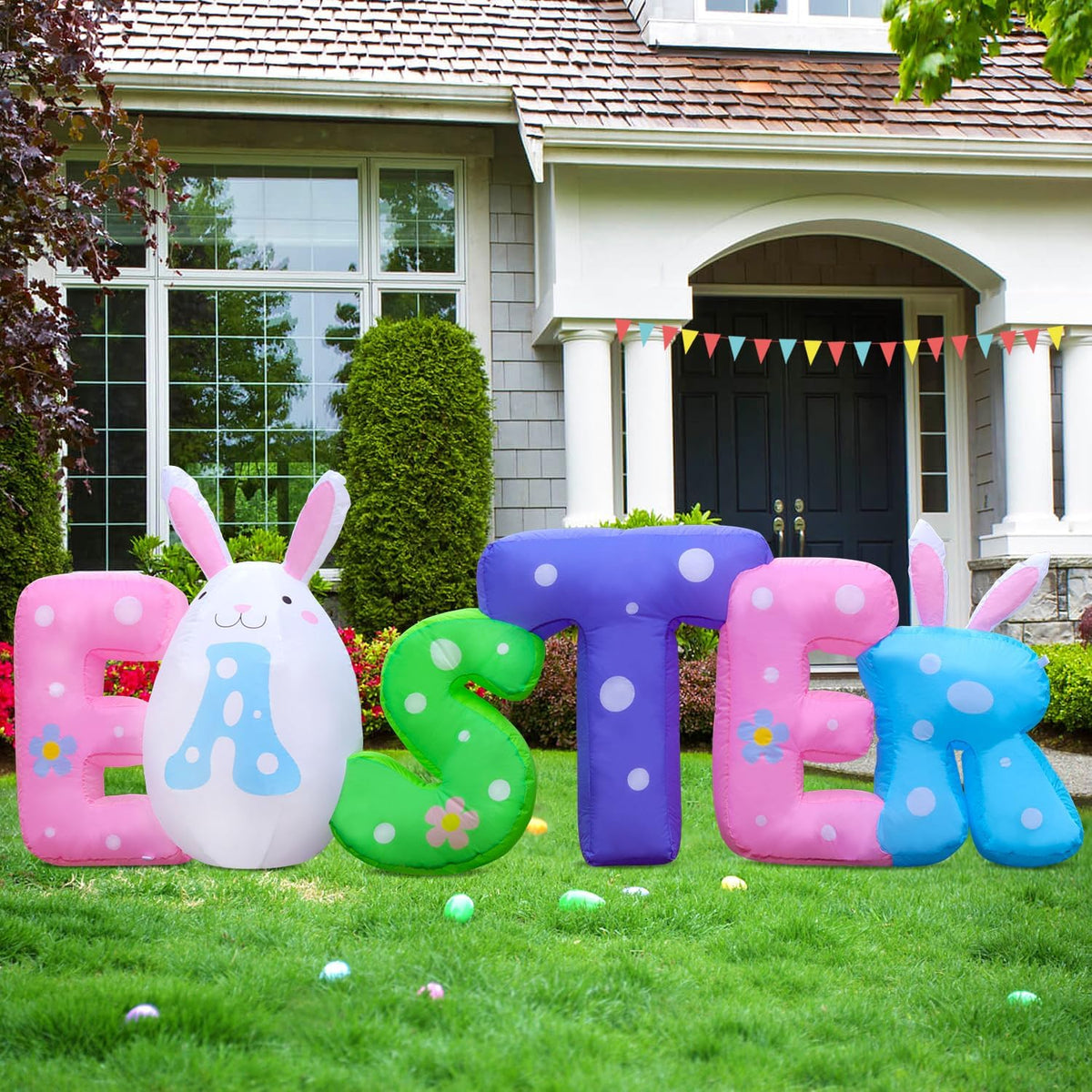 Inflatable pastel EASTER letters with bunny ears on a front lawn